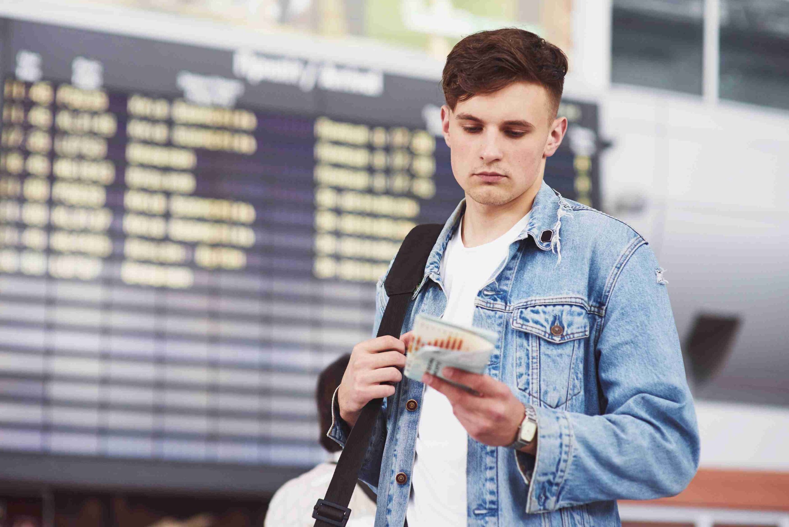 young-handsome-man-with-bag-his-shoulder-hurry-airport (2) (1)