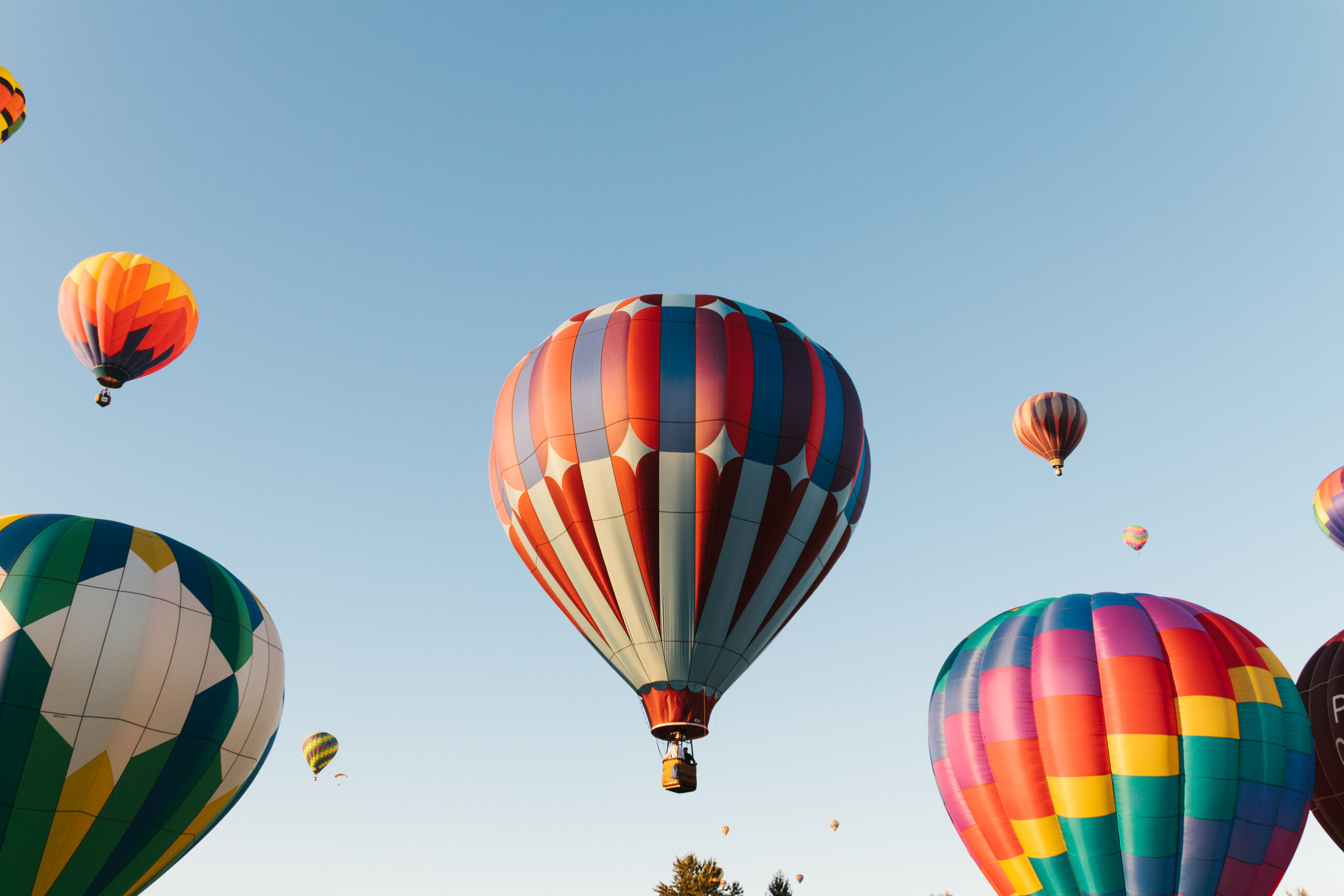 low-angle-view-hot-air-balloons-against-clear-sky